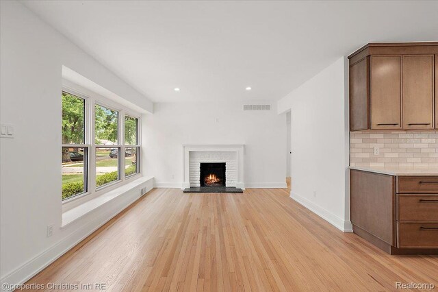 15589 Kirkshire Ave, Beverly Hills, MI 48025 - unfurnished living room with a fireplace, light wood-type flooring, and recessed lighting