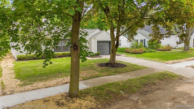 15589 Kirkshire Ave, Beverly Hills, MI 48025 - obstructed view of property with driveway, a garage, and a front yard