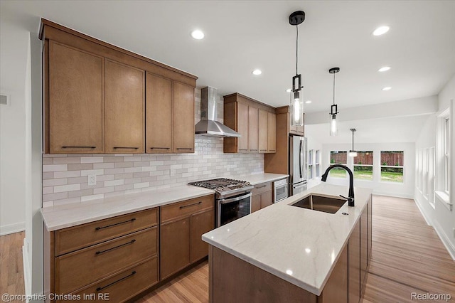 15589 Kirkshire Ave, Beverly Hills, MI 48025 - kitchen with stainless steel appliances, wall chimney range hood, tasteful backsplash, light wood-style floors, and recessed lighting