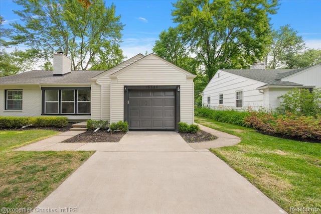 15589 Kirkshire Ave, Beverly Hills, MI 48025 - view of front of home with a garage, a front lawn, driveway, and a chimney