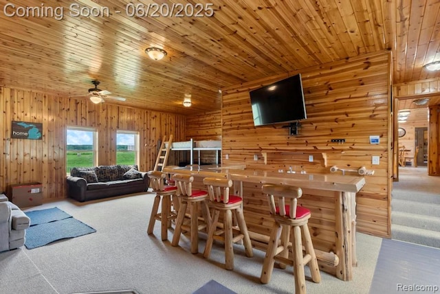 18031 State Highway M28, Newberry, MI 49868 - carpeted dining room featuring wood walls, ceiling fan, wooden ceiling, and a dry bar