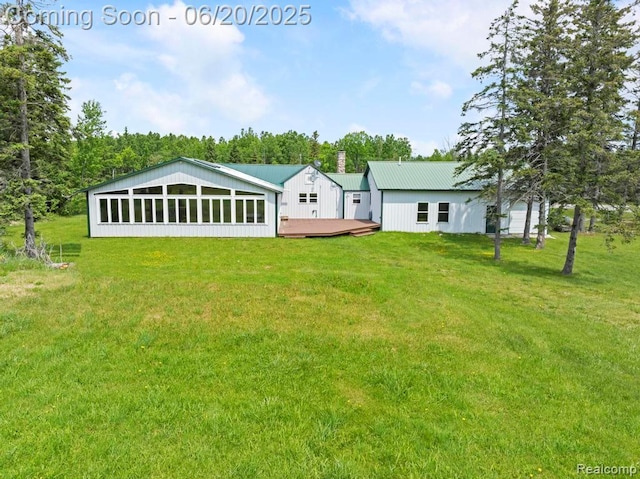 18031 State Highway M28, Newberry, MI 49868 - back of house with a wooden deck, a yard, a metal roof, and view of wooded area