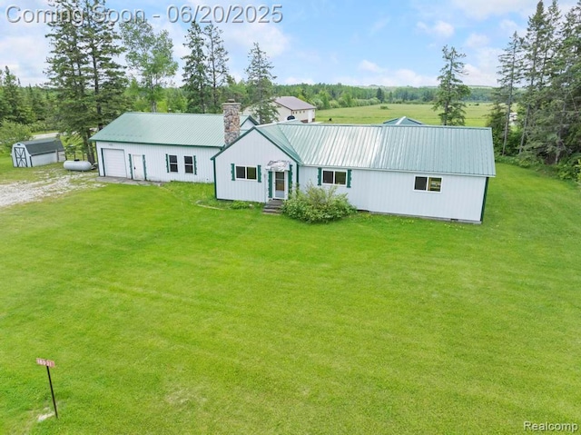 18031 State Highway M28, Newberry, MI 49868 - view of front facade with a metal roof, a chimney, a front lawn, dirt driveway, and an outdoor structure