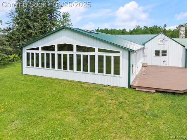 18031 State Highway M28, Newberry, MI 49868 - back of property with a deck, a yard, a metal roof, and a chimney