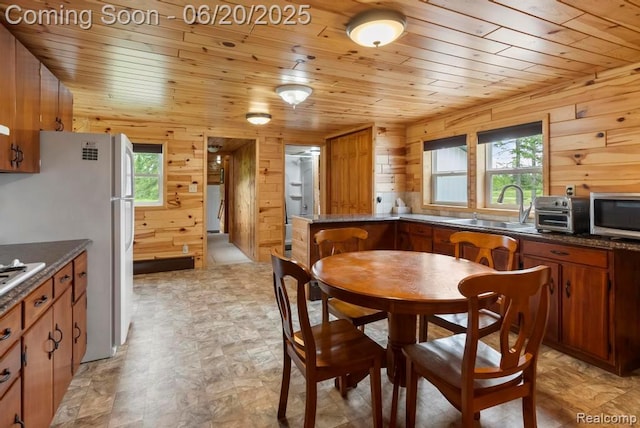 18031 State Highway M28, Newberry, MI 49868 - dining room featuring wooden ceiling, wood walls, and healthy amount of natural light