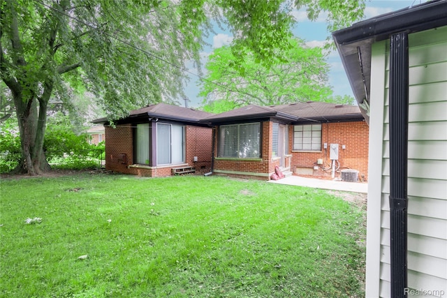 16788 Lincoln Ave, Eastpointe, MI 48021 - rear view of property with brick siding, a yard, and a patio area