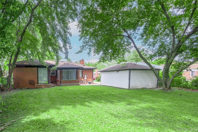 16788 Lincoln Ave, Eastpointe, MI 48021 - rear view of house with a lawn, a chimney, and brick siding