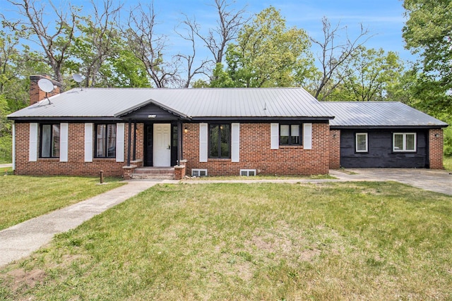 6236 Arbutus, Idlewild, MI 49642 - ranch-style house with a front yard, a metal roof, and brick siding