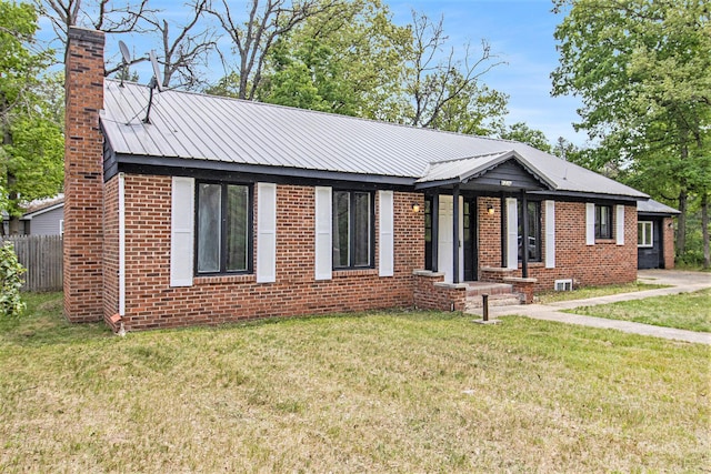 6236 Arbutus, Idlewild, MI 49642 - single story home with a chimney, brick siding, and a metal roof