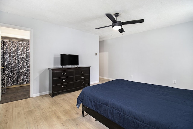 6236 Arbutus, Idlewild, MI 49642 - bedroom with light wood-style flooring and a ceiling fan
