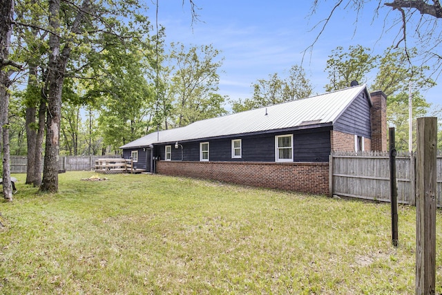 6236 Arbutus, Idlewild, MI 49642 - rear view of house with brick siding and a chimney