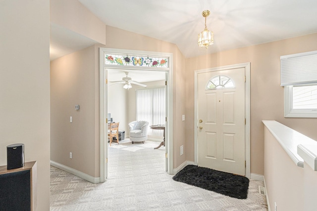 13380 Park Blvd W, Vicksburg, MI 49097 - entryway featuring plenty of natural light, lofted ceiling, light colored carpet, a chandelier, and a ceiling fan