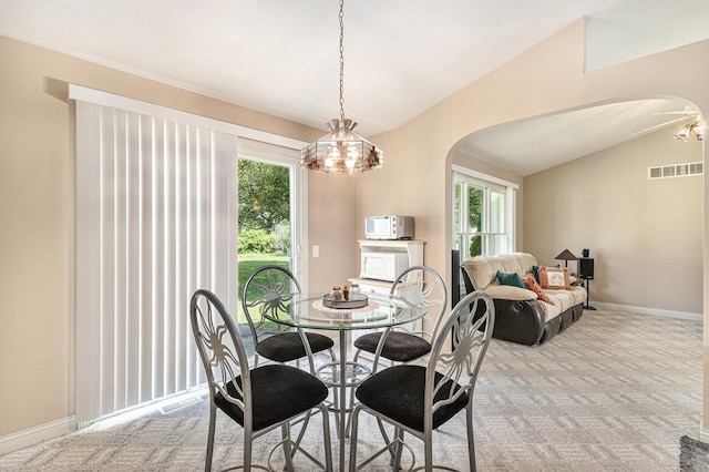 13380 Park Blvd W, Vicksburg, MI 49097 - dining area featuring arched walkways, lofted ceiling, and carpet floors