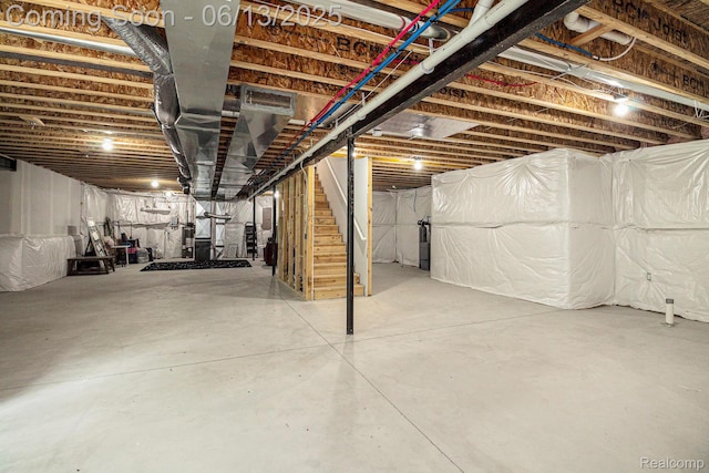 5950 Mountain Top Dr, Brighton, MI 48116 - unfinished basement featuring stairway and water heater