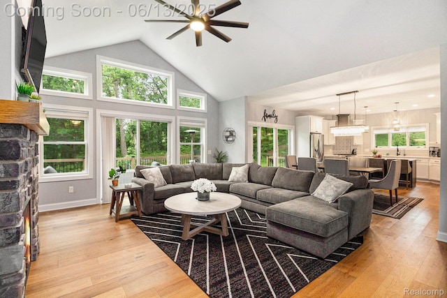 5950 Mountain Top Dr, Brighton, MI 48116 - living room with a ceiling fan, light wood-style floors, and high vaulted ceiling