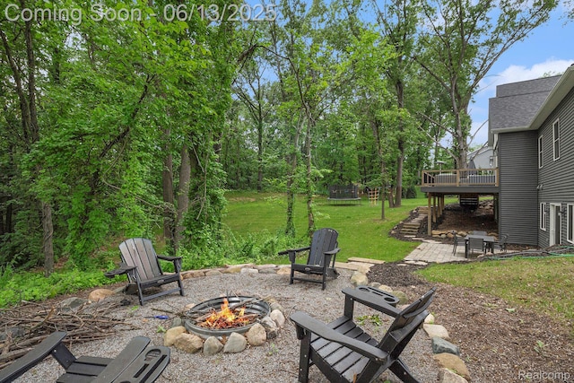 5950 Mountain Top Dr, Brighton, MI 48116 - view of patio featuring a fire pit, a wooden deck, a trampoline, and stairway