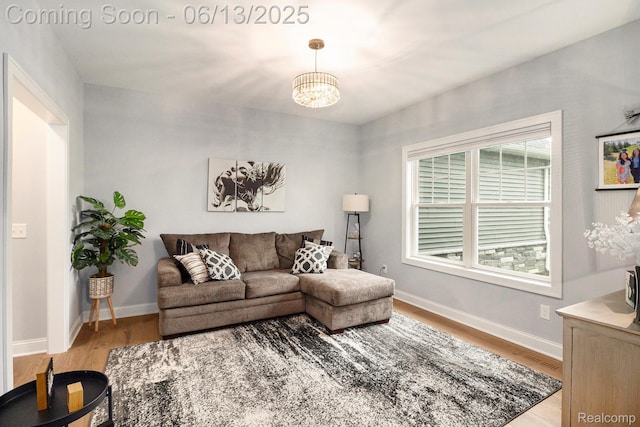 5950 Mountain Top Dr, Brighton, MI 48116 - living room featuring wood finished floors and a chandelier