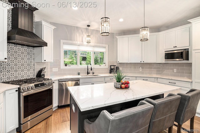 5950 Mountain Top Dr, Brighton, MI 48116 - kitchen featuring appliances with stainless steel finishes, white cabinetry, light wood finished floors, recessed lighting, and decorative backsplash