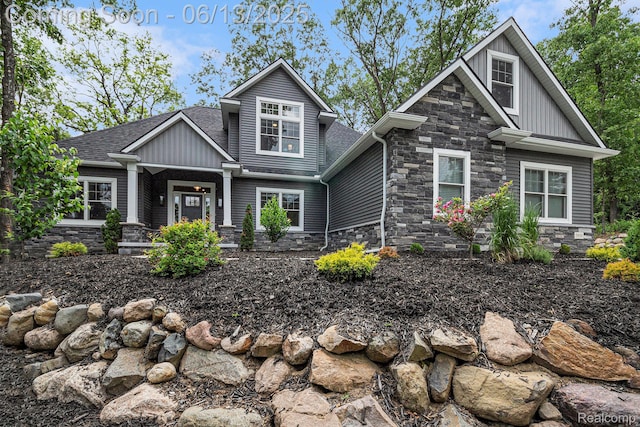 5950 Mountain Top Dr, Brighton, MI 48116 - craftsman house with stone siding, board and batten siding, and a shingled roof