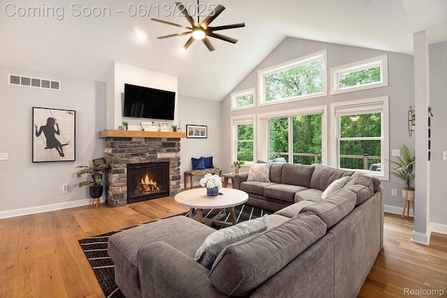 5950 Mountain Top Dr, Brighton, MI 48116 - living room with ceiling fan, a stone fireplace, high vaulted ceiling, and light wood-type flooring