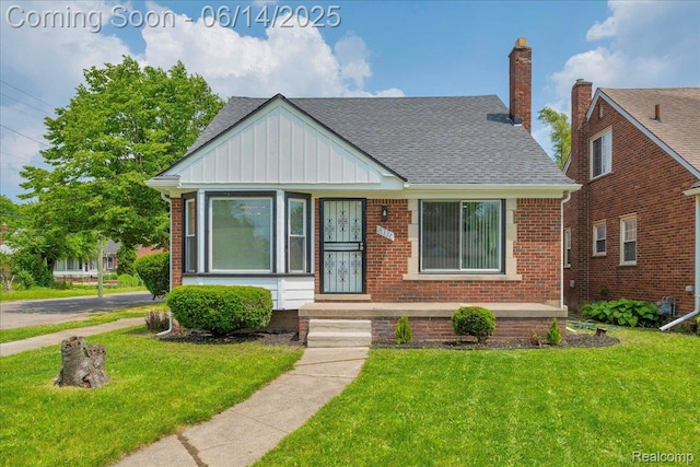 18336 Glastonbury Rd, Detroit, MI 48219 - view of front of house with board and batten siding, a front lawn, and roof with shingles