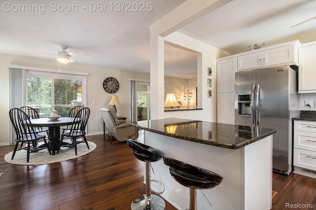 11124 Colony Rd, Pinckney, MI 48169 - kitchen with stainless steel fridge with ice dispenser, dark stone countertops, dark wood finished floors, and white cabinetry