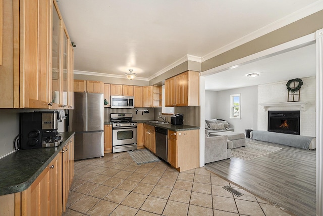 1143 S John Hix St, Westland, MI 48186 - kitchen with stainless steel appliances, open shelves, dark countertops, open floor plan, and light tile patterned flooring