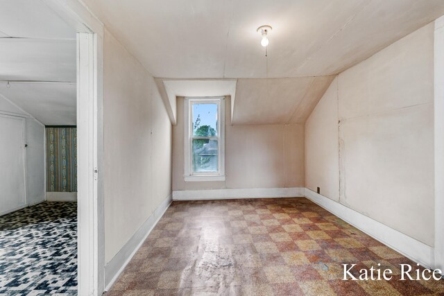8974 Park St, Montague, MI 49437 - bonus room featuring tile patterned floors and vaulted ceiling