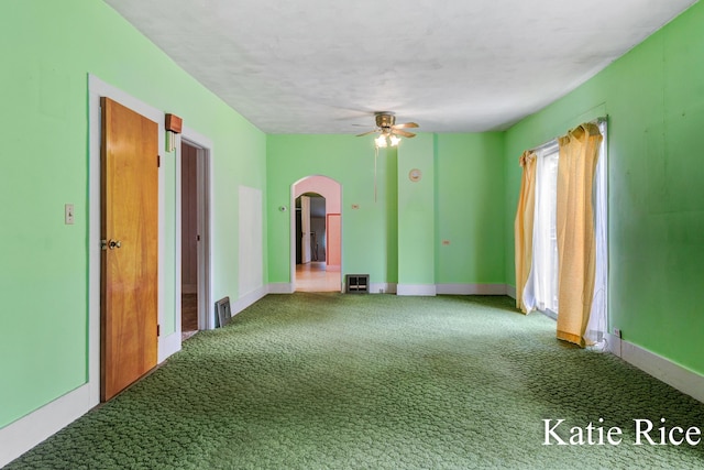 8974 Park St, Montague, MI 49437 - empty room with arched walkways, carpet, and a ceiling fan