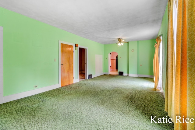 8974 Park St, Montague, MI 49437 - unfurnished room with arched walkways, carpet floors, and a ceiling fan