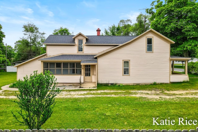 8974 Park St, Montague, MI 49437 - traditional home with roof with shingles, a front lawn, a sunroom, and a chimney