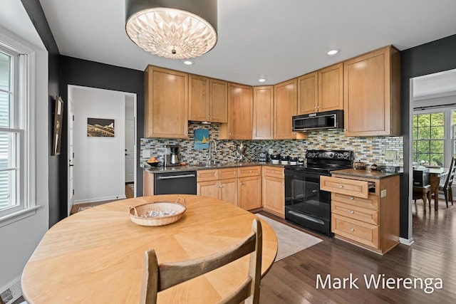 334 Terrill Ave, Grand Haven, MI 49417 - kitchen with black appliances, dark countertops, dark wood-style floors, backsplash, and recessed lighting