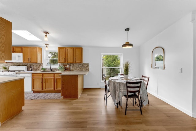 6626 Dennison Rd, Plainwell, MI 49080 - kitchen featuring white appliances, healthy amount of natural light, and light countertops