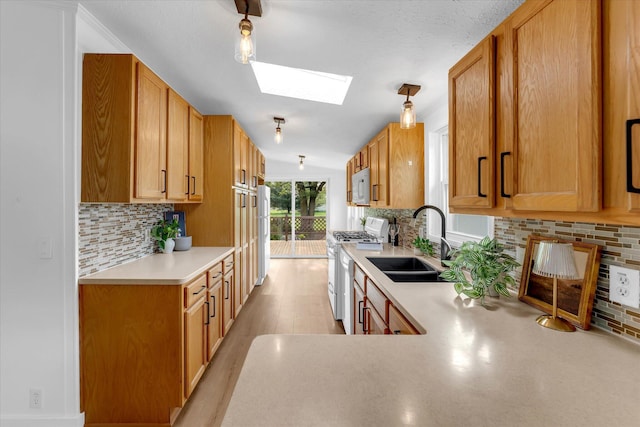 6626 Dennison Rd, Plainwell, MI 49080 - kitchen with white appliances, a skylight, light countertops, and tasteful backsplash