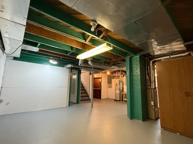 216 Bradley St, Dowagiac, MI 49047 - unfinished basement featuring gas water heater and stairs