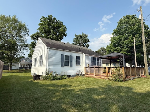 216 Bradley St, Dowagiac, MI 49047 - rear view of property with a gazebo, a lawn, a wooden deck, and a shingled roof
