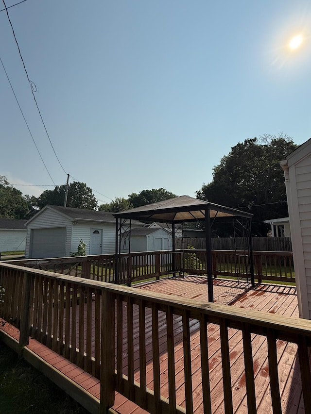 216 Bradley St, Dowagiac, MI 49047 - wooden deck with a fenced backyard, a garage, a storage shed, and a gazebo