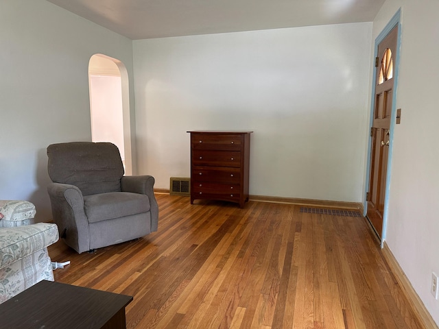 216 Bradley St, Dowagiac, MI 49047 - living area featuring hardwood / wood-style flooring and arched walkways