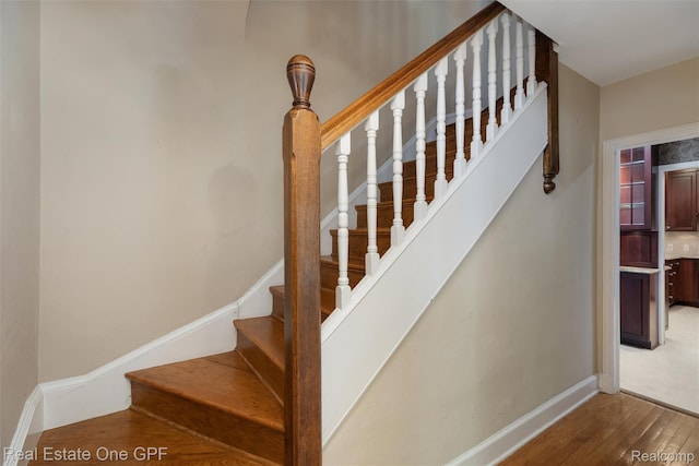 542 Cadieux Rd, Grosse Pointe, MI 48230 - staircase with wood finished floors and baseboards