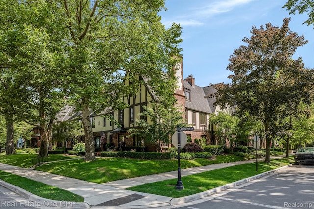 542 Cadieux Rd, Grosse Pointe, MI 48230 - english style home with a front lawn and brick siding