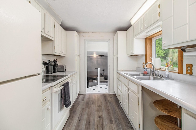 5890 N Oceana Dr, Hart, MI 49420 - kitchen with white appliances, light countertops, dark wood-style floors, white cabinetry, and a textured ceiling
