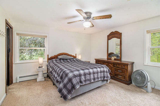 5890 N Oceana Dr, Hart, MI 49420 - bedroom with a baseboard heating unit, light carpet, and ceiling fan
