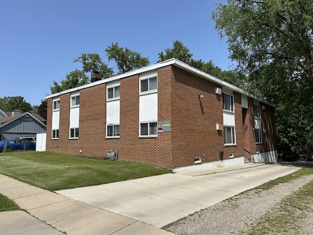 7 S Normal St, Ypsilanti, MI 48197 - view of home's exterior featuring brick siding, a yard, and a chimney