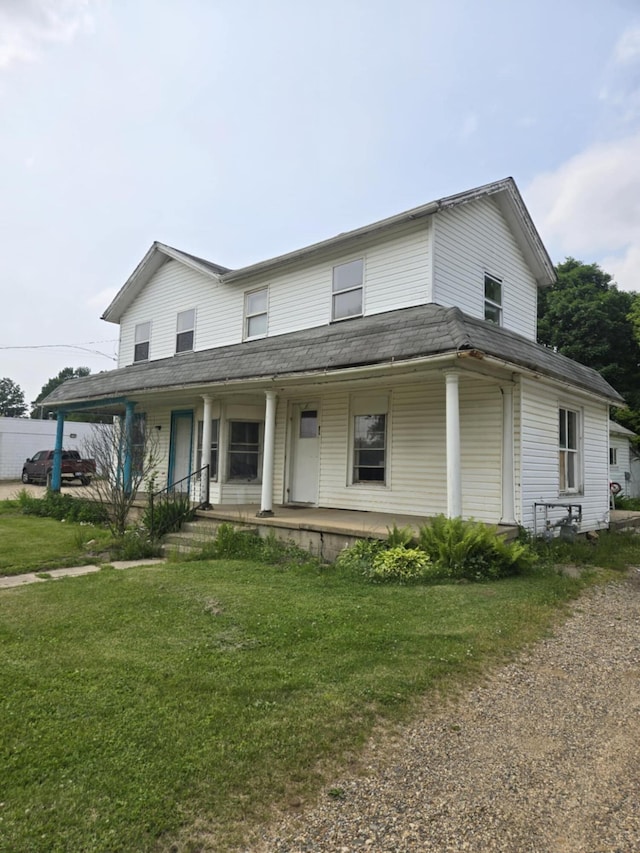 219 E Main St, Springport, MI 49284 - farmhouse-style home with a porch and a front yard