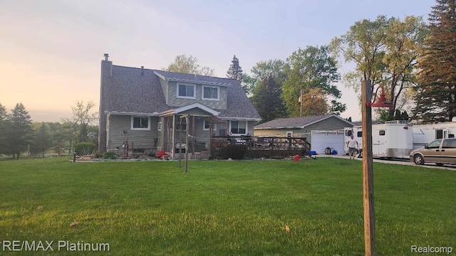 2025 W Rose Center Rd, Holly, MI 48442 - view of front of property with a front lawn, a chimney, a garage, and an outdoor structure
