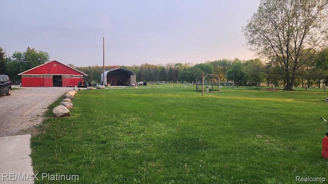 2025 W Rose Center Rd, Holly, MI 48442 - view of grassy yard featuring a carport, a pole building, and an outbuilding