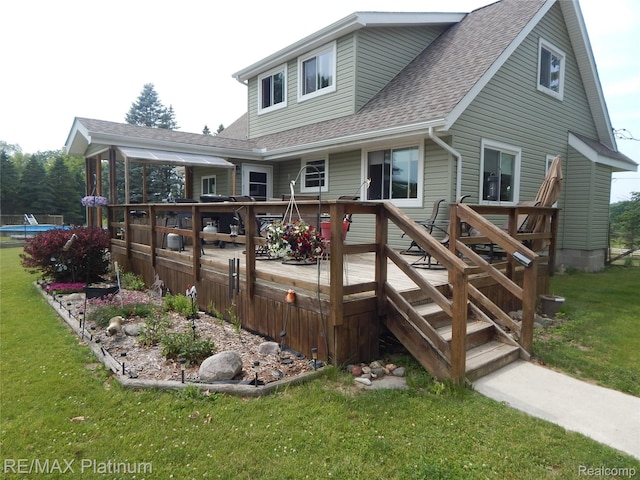 2025 W Rose Center Rd, Holly, MI 48442 - back of property with a shingled roof, a deck, and a lawn