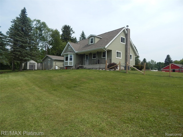 2025 W Rose Center Rd, Holly, MI 48442 - view of front of house with a chimney, a porch, a storage unit, a front yard, and a shingled roof