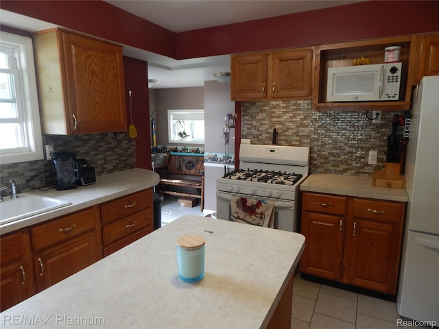 2025 W Rose Center Rd, Holly, MI 48442 - kitchen featuring white appliances, light countertops, and tasteful backsplash