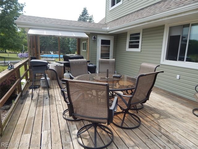 2025 W Rose Center Rd, Holly, MI 48442 - wooden deck featuring a jacuzzi and outdoor dining space
